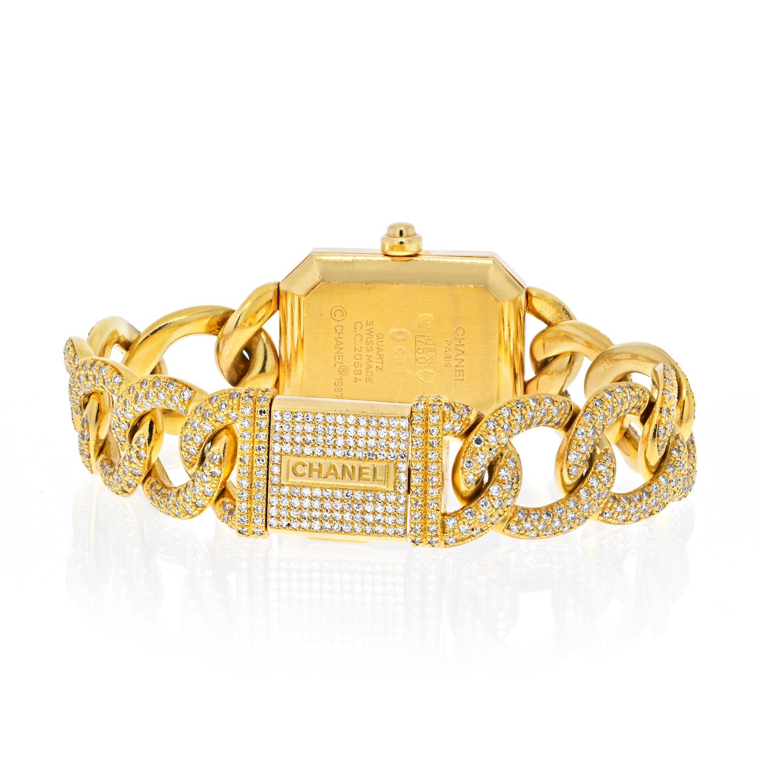 Chanel Gold Première Diamond Quartz Model H0114 Ladies Watch.

18K yellow gold 20mm x 26mm Chanel Premiere Chaine watch featuring a quartz movement, black dial with baton hands, diamond bezel, 18K yellow gold and pave diamond chain bracelet with