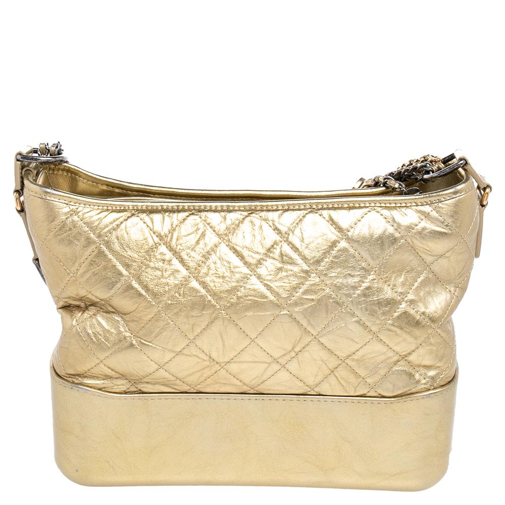 Get yourself this beautiful Gabrielle shoulder bag from the iconic house of Chanel. It exudes style and will always deliver a classy look. Crafted in Italy using aged leather, it comes in a dazzling gold shade. The bag flaunts the signature quilted