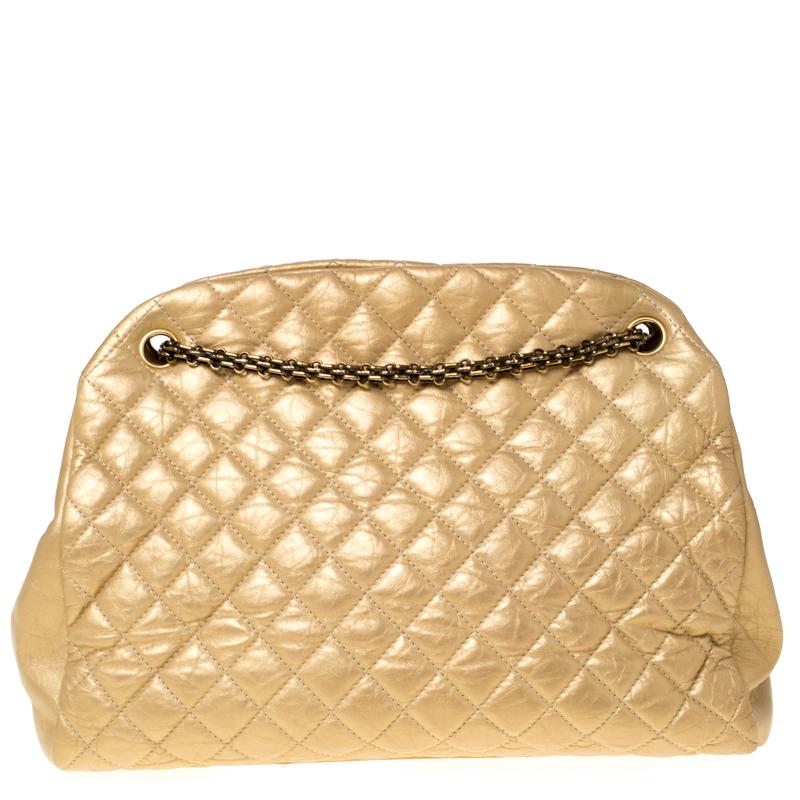 Spacious and captivating, this Just Mademoiselle Bowler bag is from Chanel. It has been crafted from gold leather and features the iconic quilted pattern. It is equipped with two chain handles and a well-sized fabric interior to keep your essentials