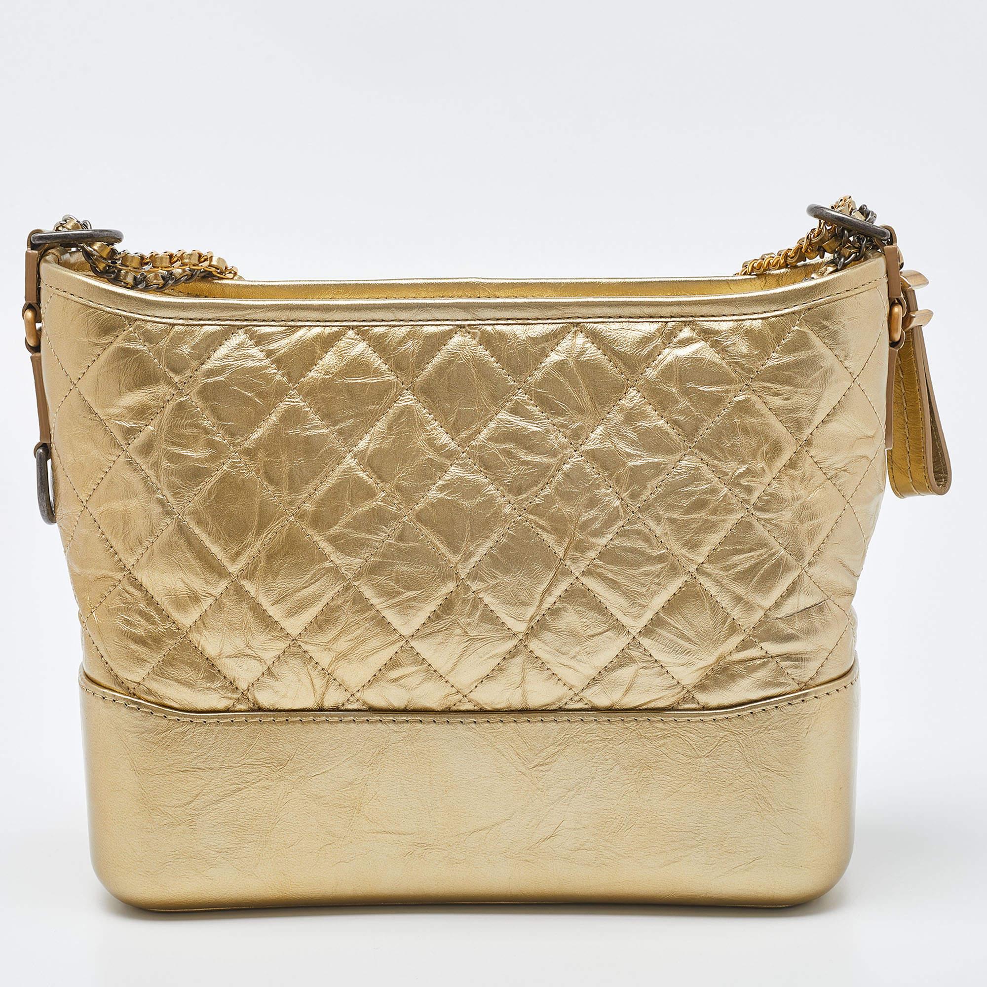 The Chanel Gabrielle hobo exudes timeless elegance. Crafted from luxurious quilted leather, its medium size strikes a perfect balance between functionality and style. The iconic chain strap adds a touch of edgy sophistication, while the gold hue