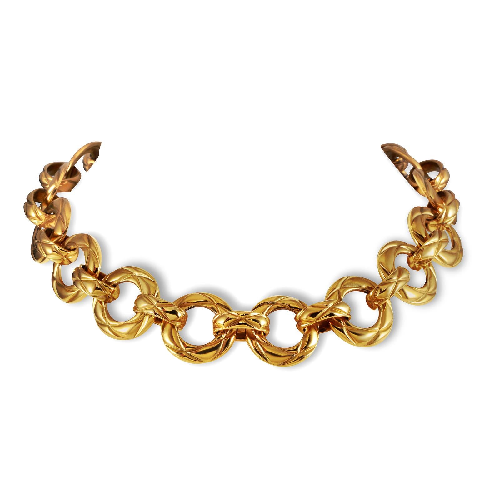 This authentic Chanel Gold Quilted Ring Choker is in excellent vintage condition from the 1970’s. A striking piece that features gold symmetrical rings with signature Chanel diamond quilted pattern.   Made in France. Pouch or box included.
