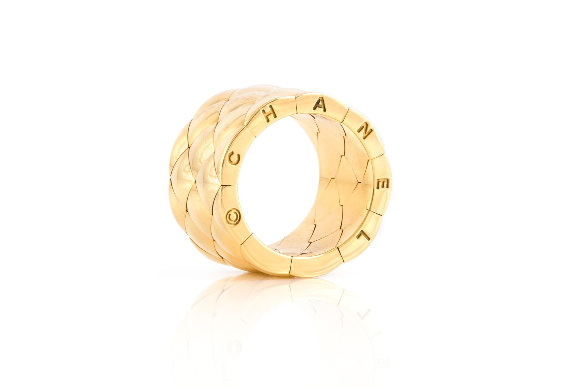 Signed by Chanel finely crafted in 18 k yellow gold ring. Ring size 7.75 and 0.5'' width.
