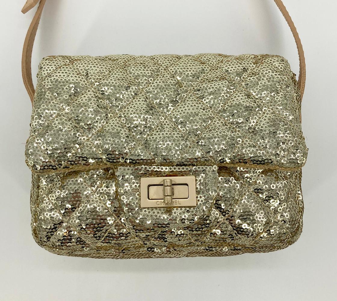 Chanel Gold Sequin Mini Reissue Classic Flap Messenger Bag in excellent condition. Gold sequin exterior trimmed with matte gold hardware and a tan leather adjustable shoulder strap. Mademoiselle style twist front closure opens via single flap to a