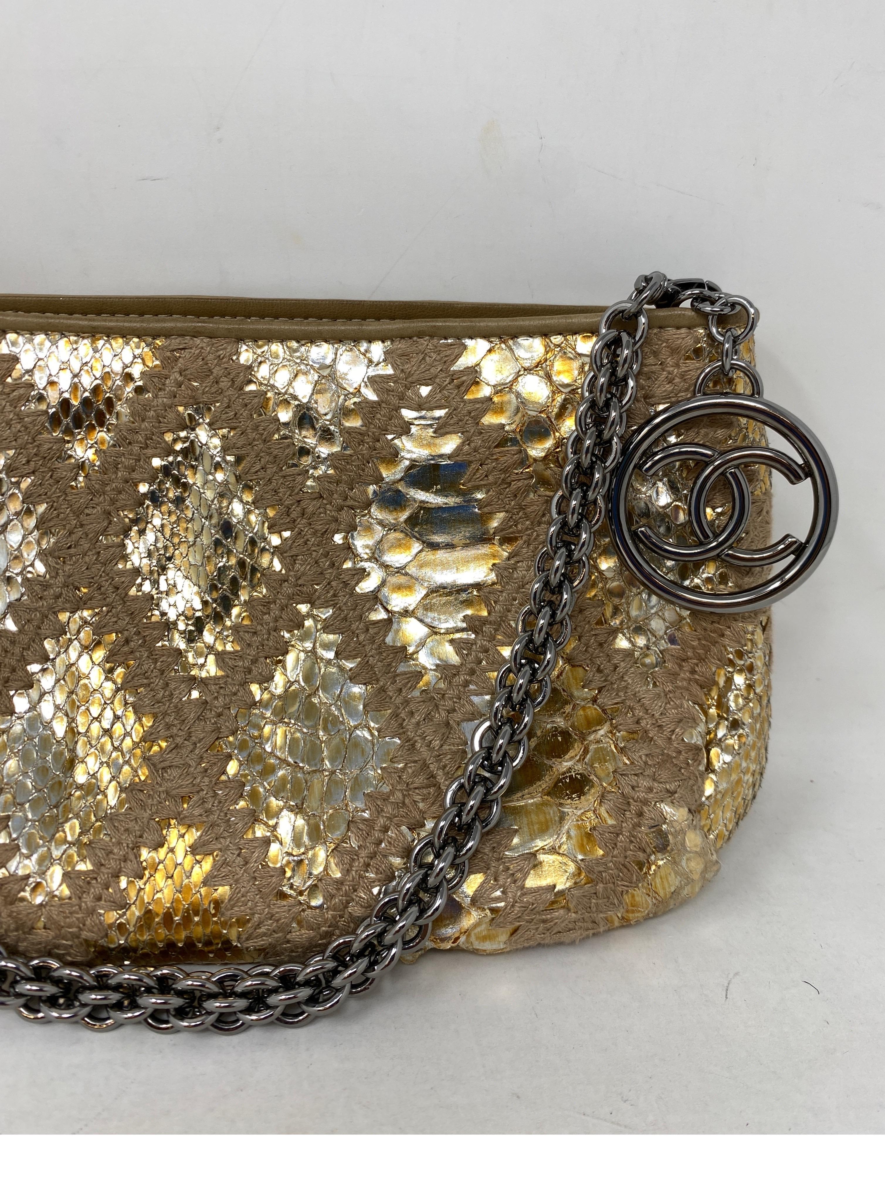 Chanel Gold Snakeskin Clutch. Excellent condition. Gold and silver clutch and pouch bag. Can be worn as a small shoulder bag. Great evening attire accessory or statement piece. Interior clean. Ruthenium strap and hardware. Includes authenticty card.