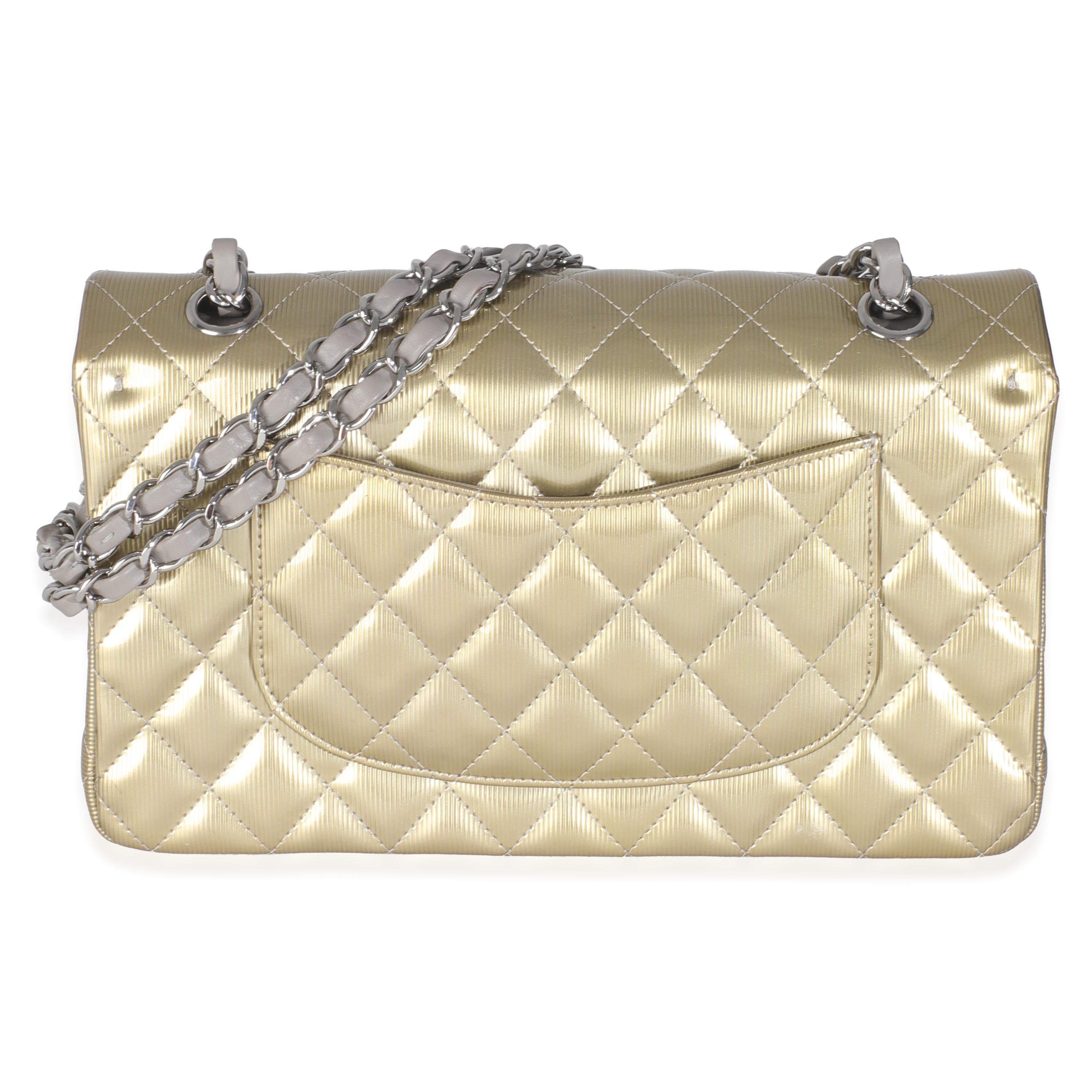 Listing Title: Chanel Gold Striated Quilted Patent Medium Classic Double Flap Bag
SKU: 145992
Condition: Pre-owned 
Condition Description: A timeless classic that never goes out of style, the flap bag from Chanel dates back to 1955 and has seen a