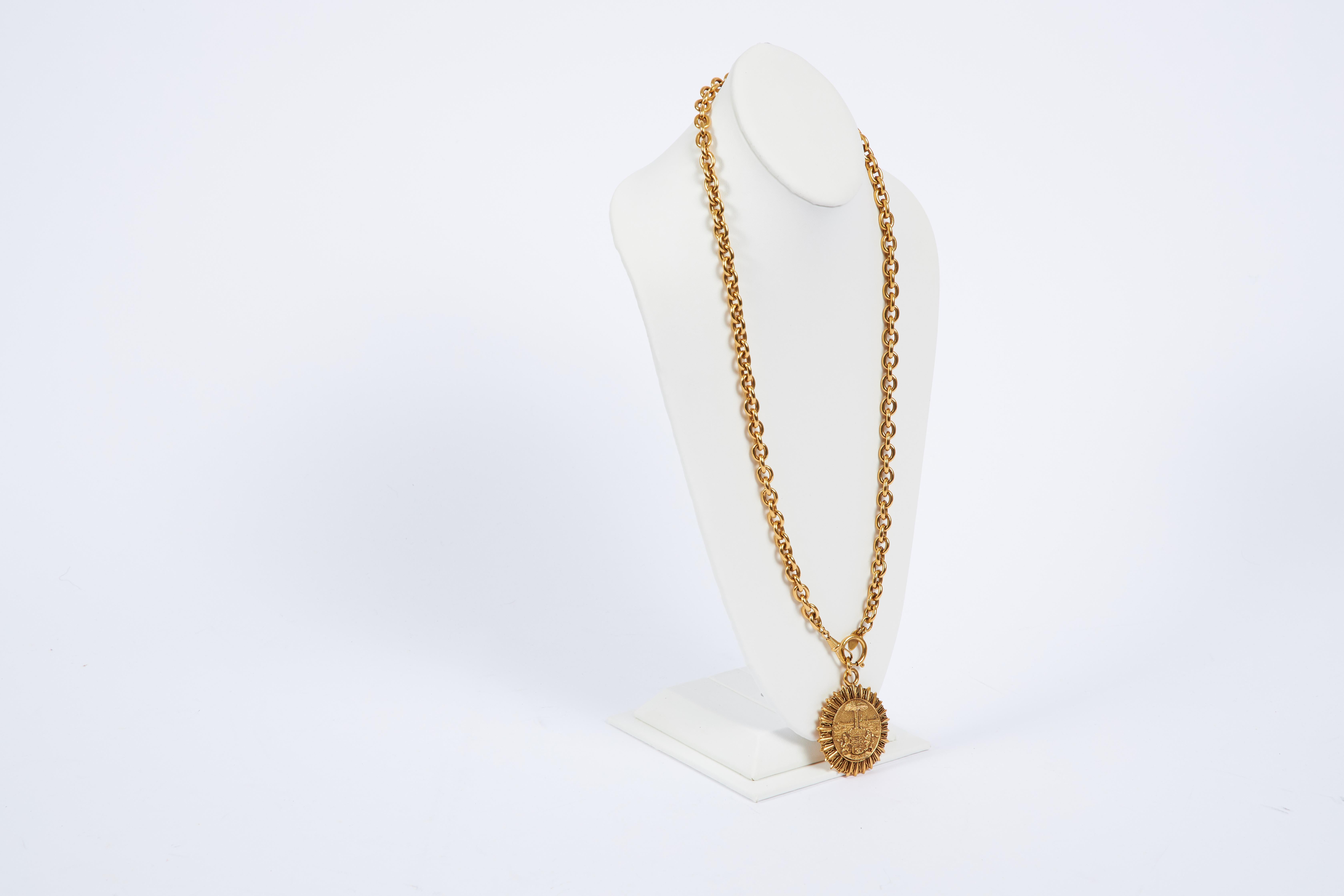 1980s Chanel gold tone metal sun tarot pendant necklace. Comes with original pouch or box.