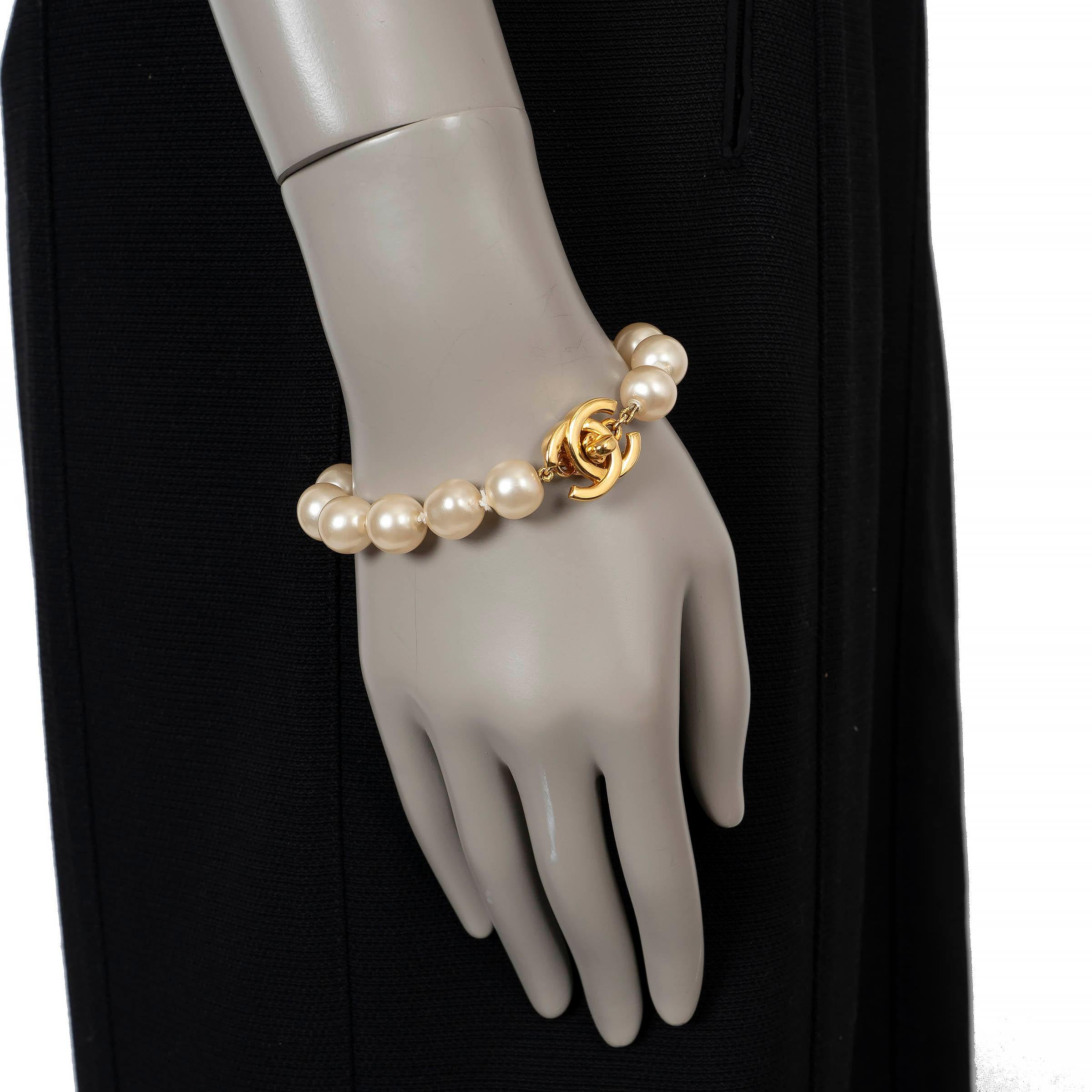 These 100% authentic Chanel bracelet is crafted in pearly white imitation pearls and finished with the house’s signature gold-tone CC turn-lock closure. A timeless, feminine piece that captures Chanel’s classic elegance with a modern touch. Has been