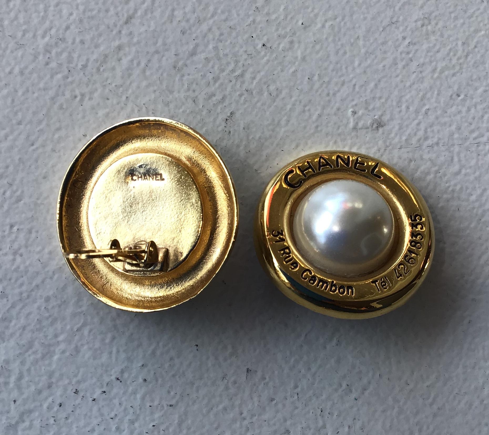 Chanel Gold Tone Cambon 31 Rue Faux Pearl Clip On Earrings. Vintage CHANEL (Circa 1954-1971) round clip on earrings come in yellow gold tone metal with 