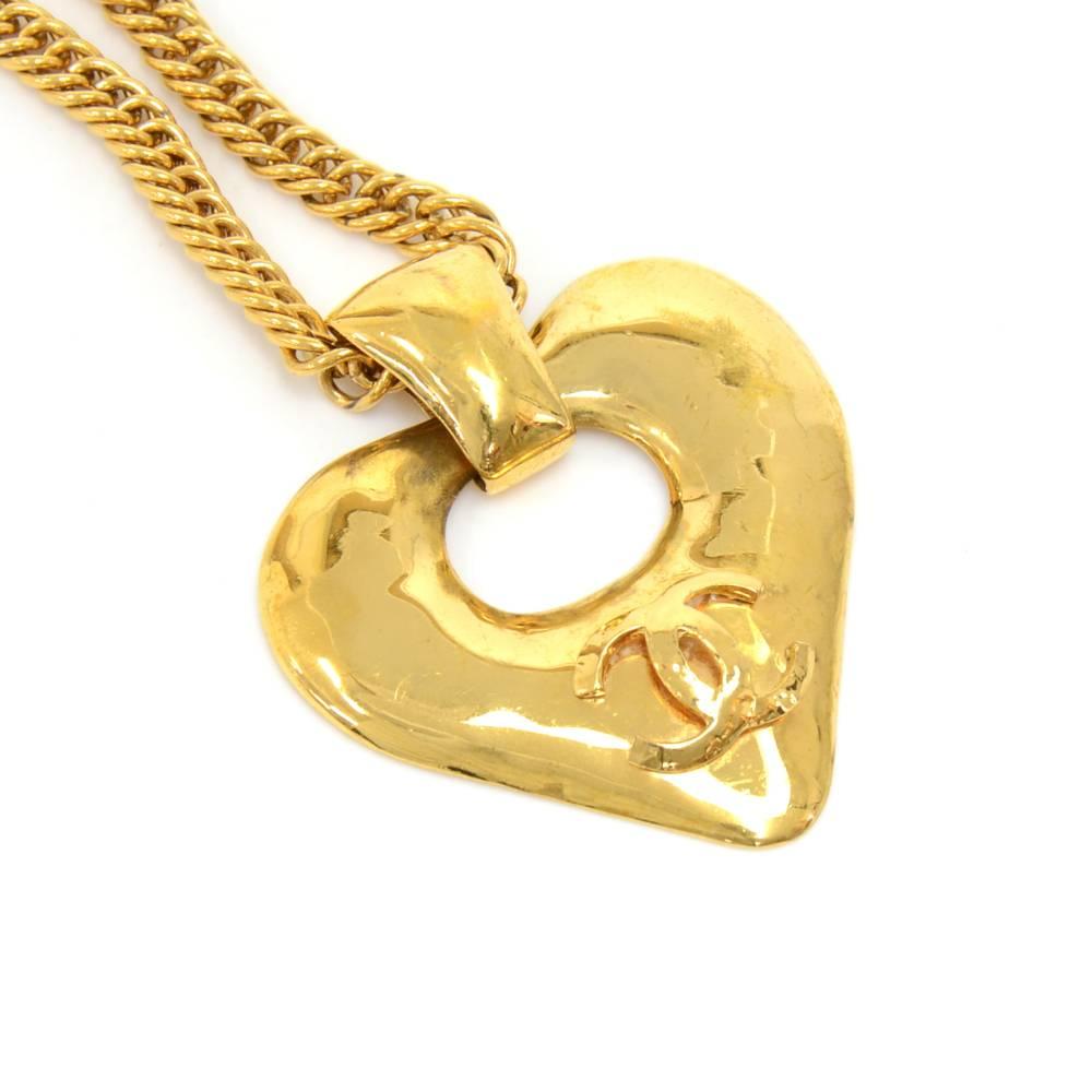 Chanel gold-tone chain necklace with a heart shaped pendant. The heart shaped pendant has  a large CC logo on the front. The necklace has a large spring ring clasp. Has 