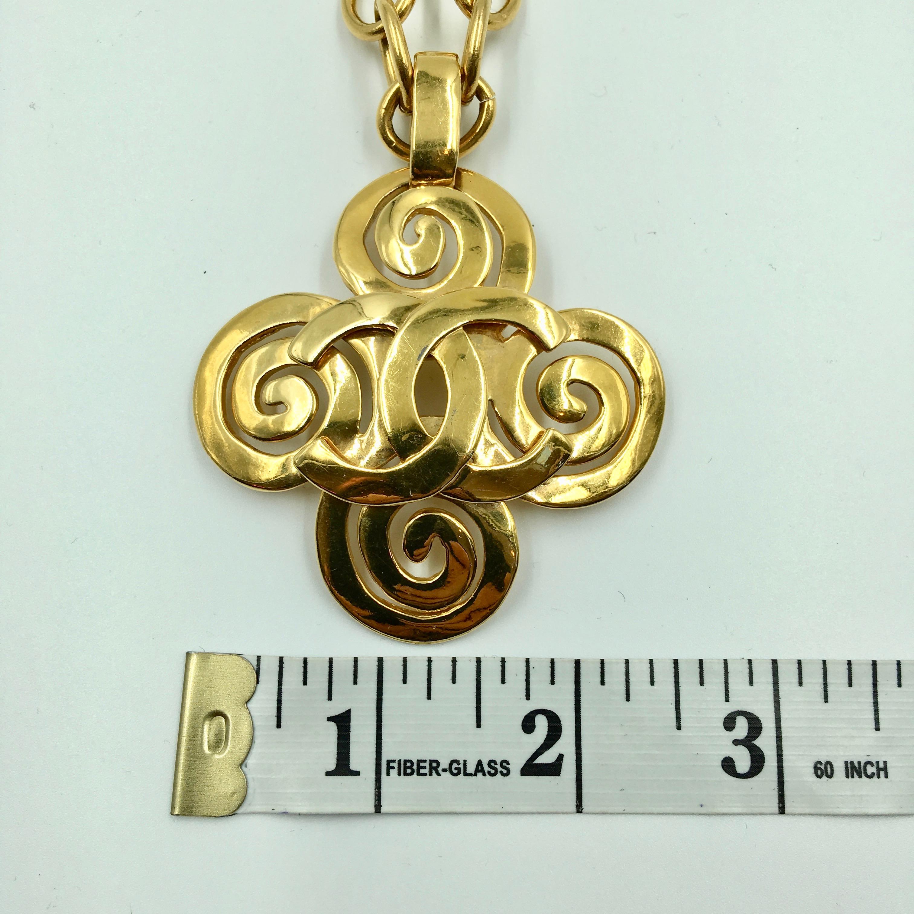 Contemporary Chanel Gold Tone CC Logo Swirl Cross Necklace For Sale
