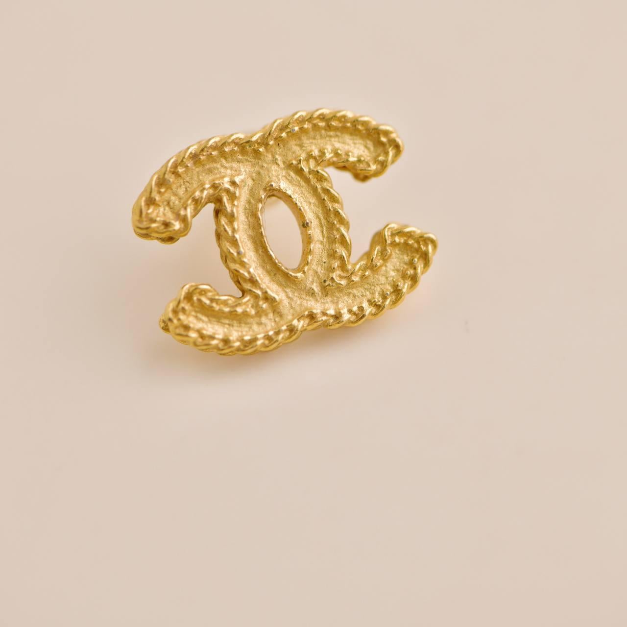 Women's or Men's Chanel Gold Tone CC Stud Earrings For Sale