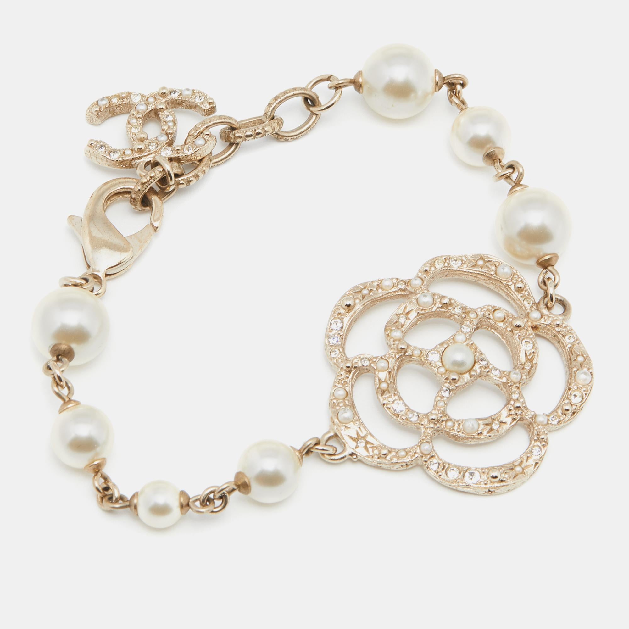 Be it to your dinner outfit or summer dress, this Chanel bracelet will surely add an elegant touch. It is crafted from gold-tone metal and added with a CC logo, a Camellia charm, and beads.

