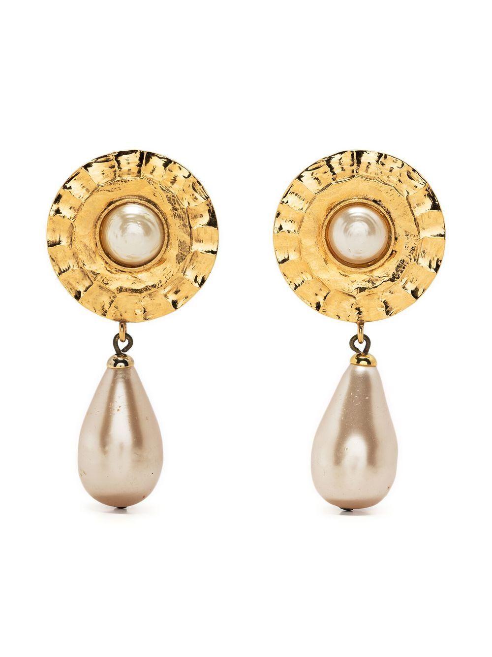 1980s Chanel long gold-tone clip-on earrings featuring a round shape with a faux-pearl bead, a long faux-pearl drop, a clip-on fastening, back plaque pitted. 
Circa 1980s
These earrings come as a pair.
Length: 2.3in. (6cm)
In good vintage condition.