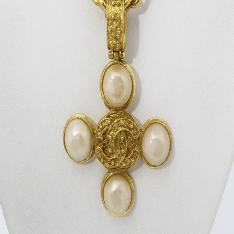 This Chanel necklace features gold-tone hardware, a cross pendant with interlocking CC logo at center and four white faux pearls and spring ring closure.


72646MSC