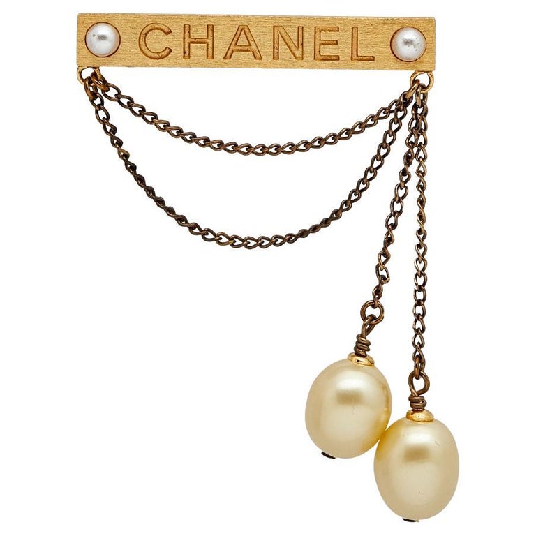 Chanel Gold Tone Pearl Logo Chain Pin Brooch at 1stDibs