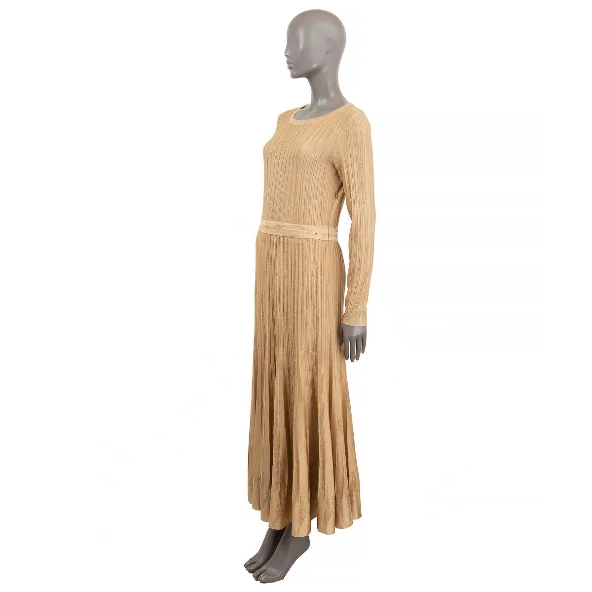 100% authentic Chanel lurex pleated knit maxi dress in gold viscose (82%), polyamide (11%) and polyester (7%). Features a round neck, long sleeves and elastic waist band with a gold-tone and pearl button. Opens with a zipper on the side. Unlined.