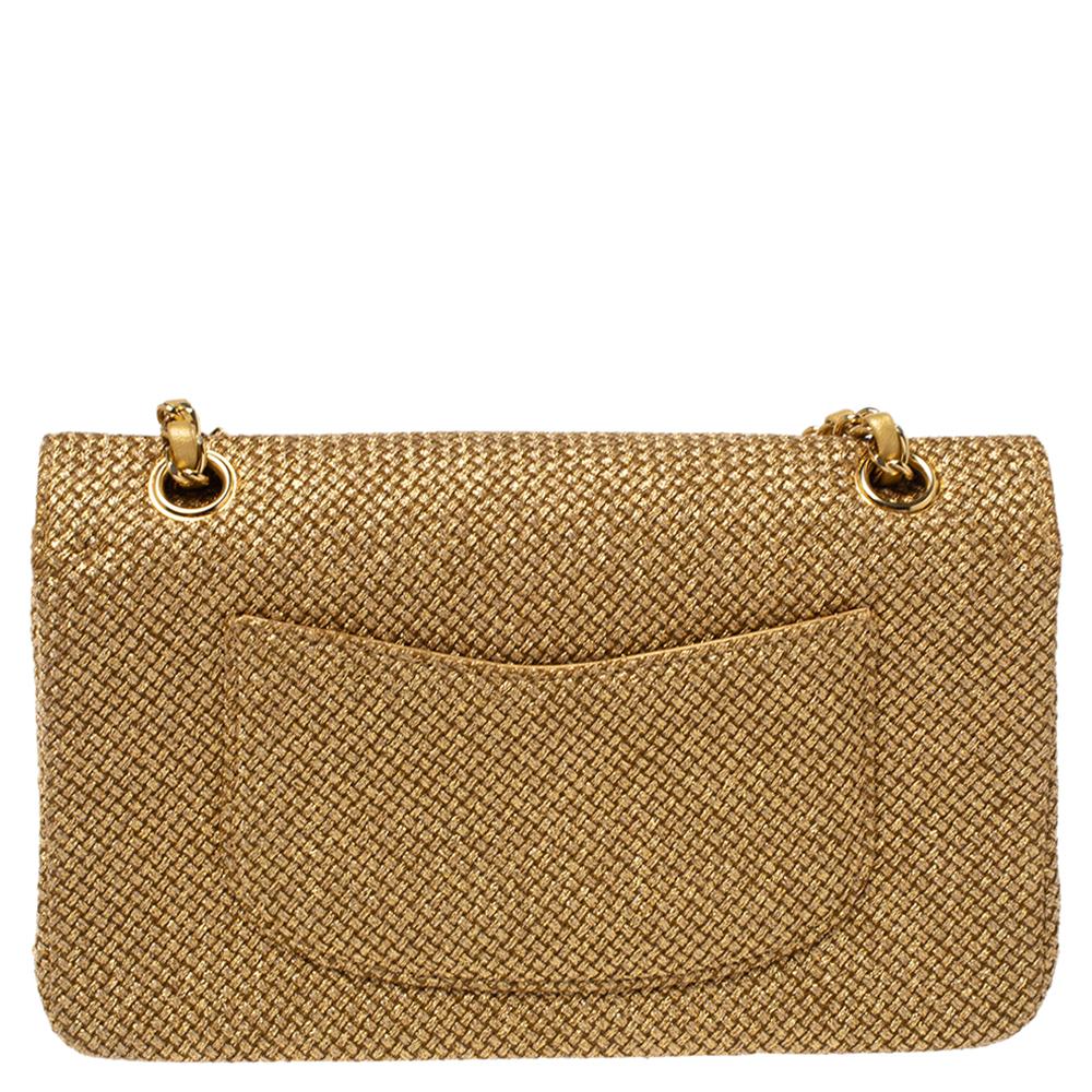 We are in utter awe of this flap bag from Chanel as it is appealing in a surreal way. Exquisitely crafted from woven raffia and exhibiting floral details on the front, it bears their signature label on the leather interior and the iconic CC