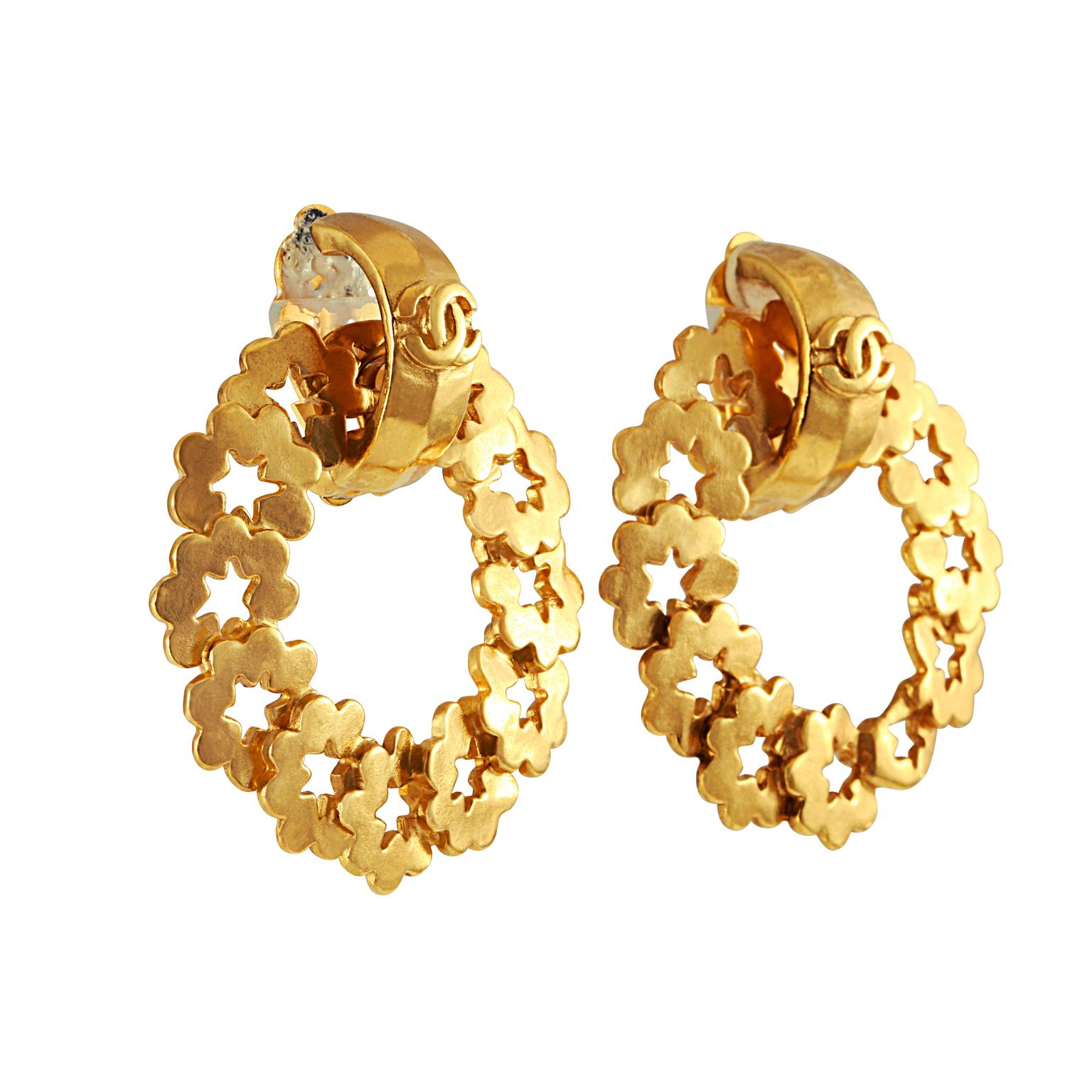 These authentic Chanel Gold Wreath Earrings are in very good vintage condition from the mid 1990’s.   Gold wreath hoops made of individual star cutouts dangle from a CC huggie.  Clip on style. Made in France.  Pouch or box included.

