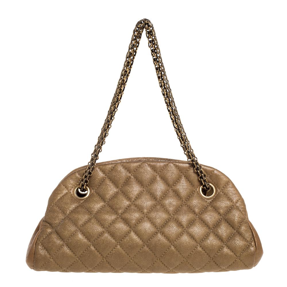 Spacious and captivating, this Just Mademoiselle Bowler bag is from Chanel. It has been crafted from quilted leather and features a lovely shape and design. It is equipped with two chain handles and well-sized canvas compartments to keep your