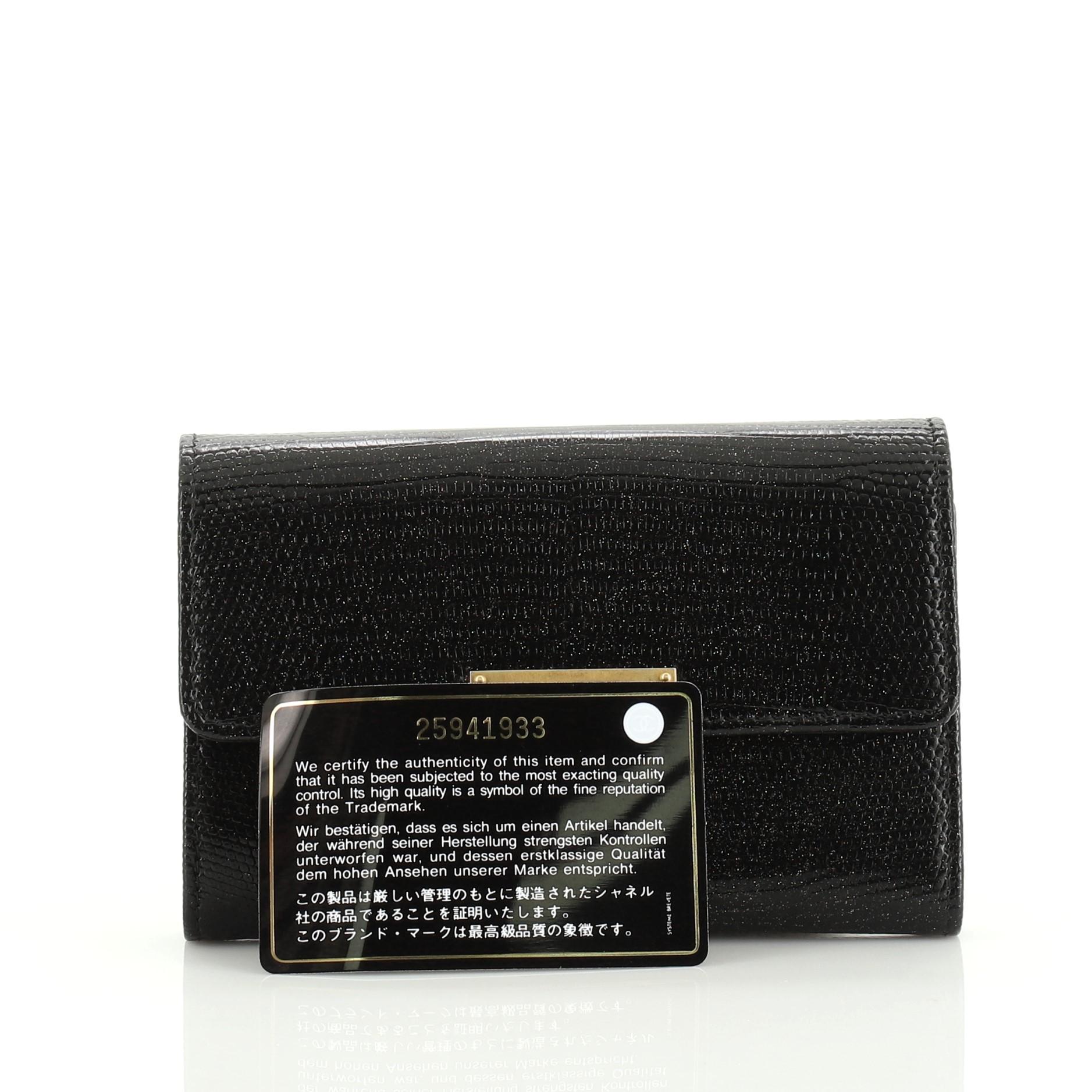 This Chanel Golden Class Wallet Lizard Small, crafted in genuine black and multicolor lizard, features gold-tone hardware. Its CC flip clasp closure opens to a black leather interior with zip pocket and multiple card slots. Hologram sticker reads: