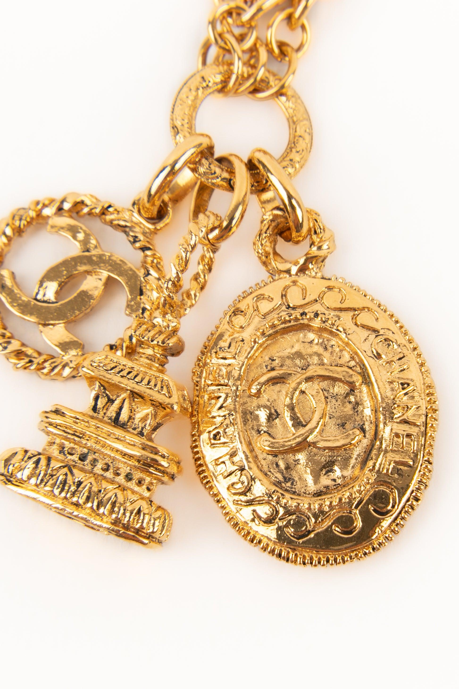 Chanel Golden Metal Bracelet with Charms, 1980s In Excellent Condition For Sale In SAINT-OUEN-SUR-SEINE, FR