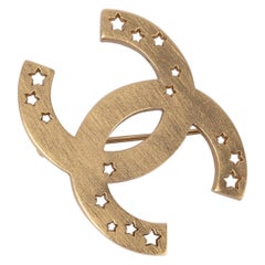 Chanel Golden Metal CC Brooch with Openwork Stars, 2004 Chanel Golden Metal CC Brooch with Openwork Stars, 2004