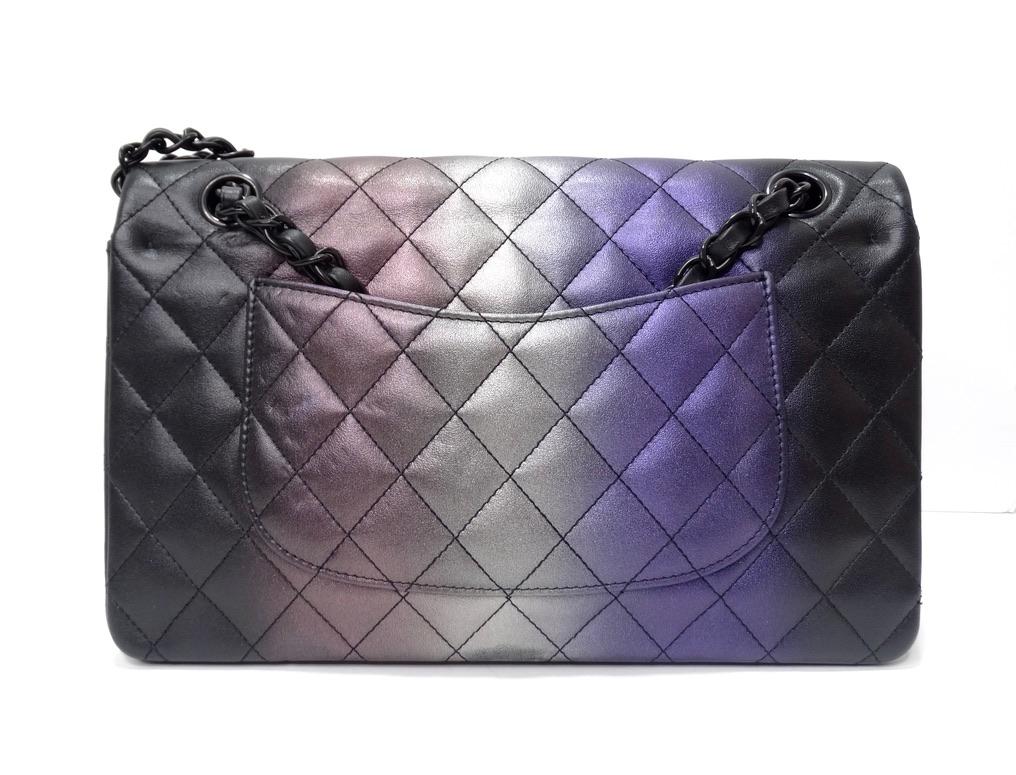 This eye catching Classic Chanel handbag is the perfect addition to any collectors wardrobe! The timelessness of the style is offset by the gorgeous gradient pastels in the center of the handbag. The bag also features a classic chain strap, a Chanel