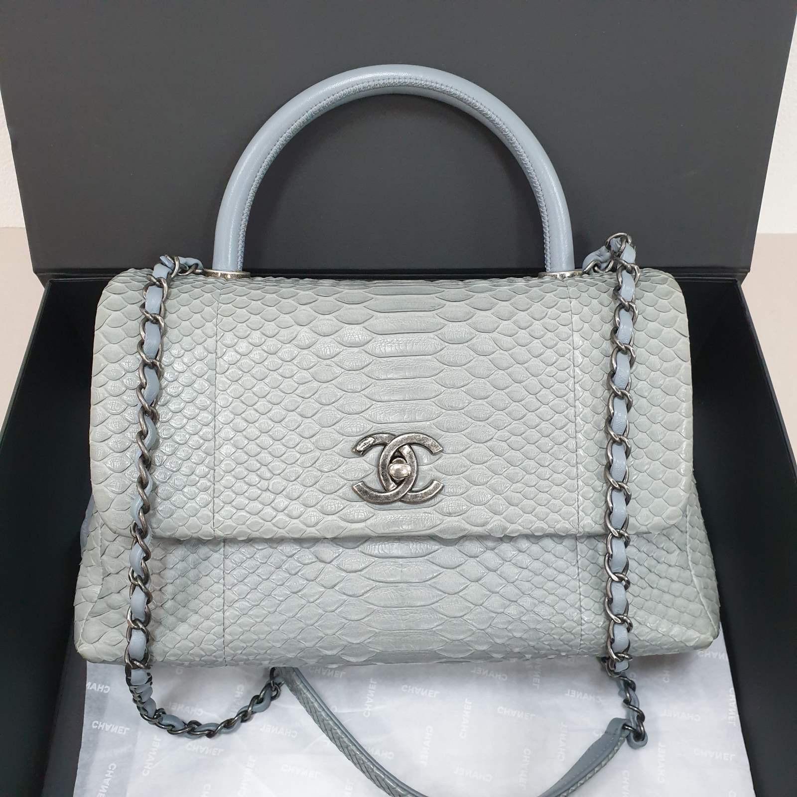 This is an authentic CHANEL Python Coco Handle Flap in Gray Blue.
This sleek classic tote is crafted of gray blue python skin.
The shoulder bag features a light blue lambskin top handle, a rear patch pocket, a leather threaded ruthenium shoulder