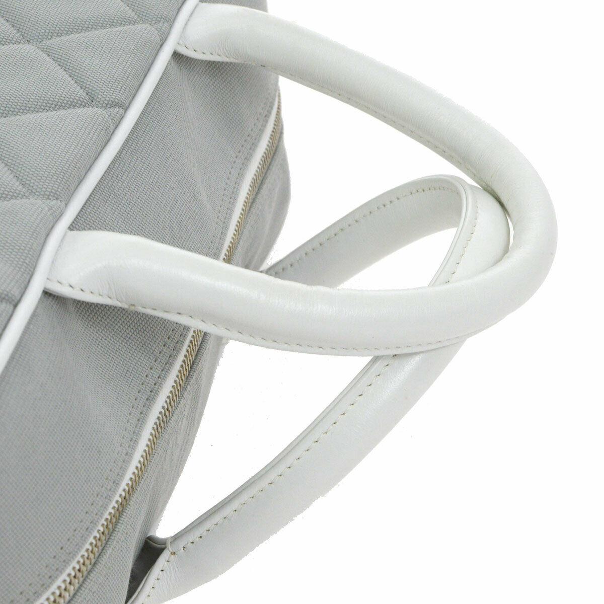 Chanel Gray White Canvas Leather Top Handle Tote Travel Carryall Bowling Bag in Box

Canvas
Leather 
Silver tone hardware 
Zipper closure
Woven lining
Made in France
Handle drop 4