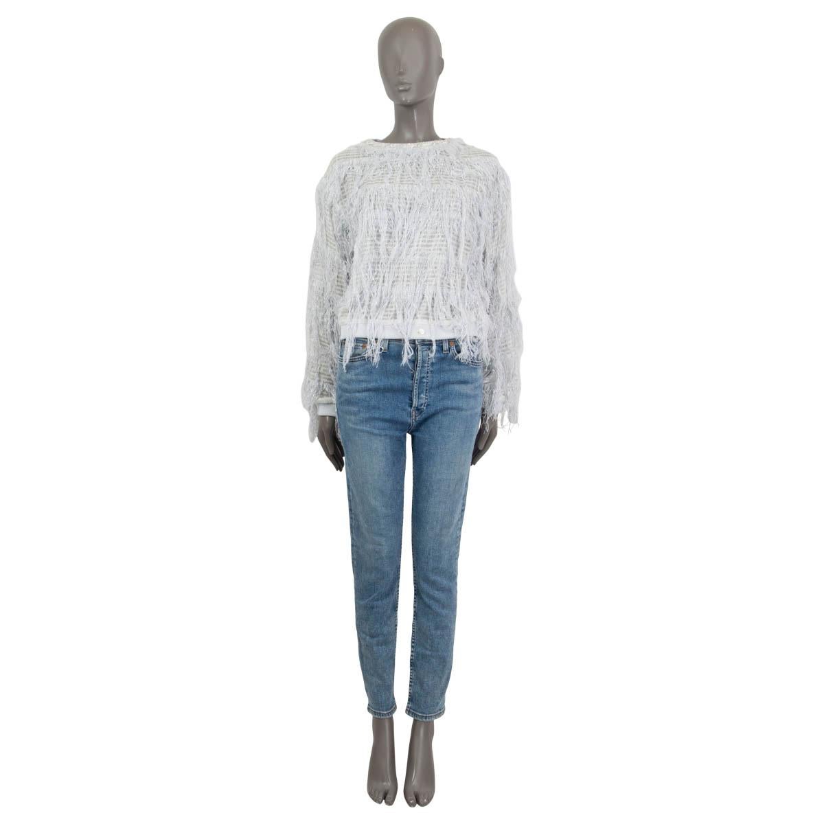 100% authentic Chanel 2018 fringed knit sweater in light gray cotton (27%), polyester (25%), polyamide (18%), viscose (18%), acrylic (10%) and metal polyester (2%). Features a lurex trim at the neck and long sleeves. Has a faux pearl 'CC' sign at