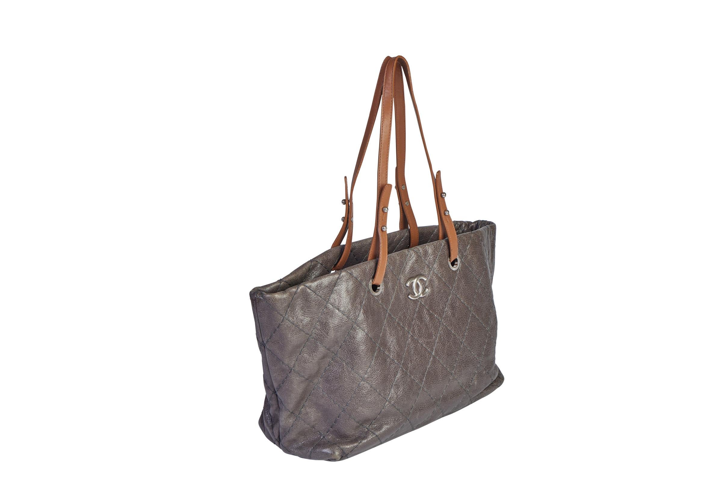 Chanel gray glazed caviar shoulder tote with front cc silver logo. Center zipped compartment, interior zipped pocket, 2 open compartments and easy find key strap. Great everyday bag. Contrasting natural brown straps. Shoulder drop 9