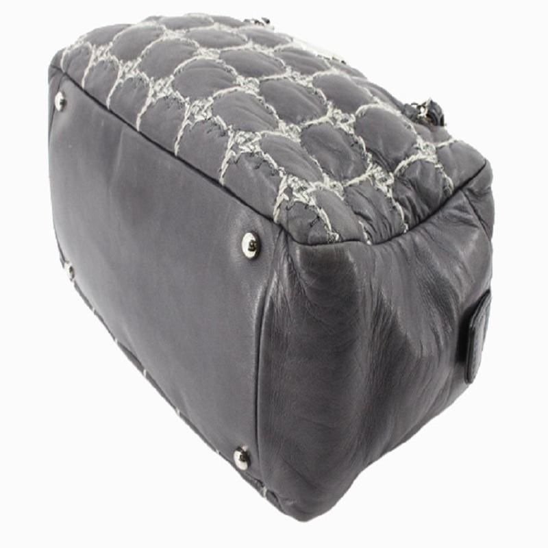 Black quilted leather Chanel Tweed On Stitch Bowler bag with silver-tone hardware, dual chain-link and leather shoulder straps, protective feet at bottom, CC logo at front, satin lining, three pockets at interior wall; one with zip closure and zip
