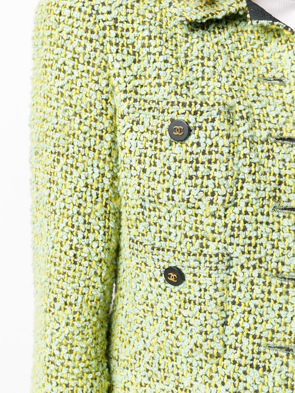 Expertly cut and crafted in France from pure tweed in a springtime palette of mint, lime and black, this long-sleeved, bouclé jacket by Chanel boasts a classic collar, a straight hem and a distinctive, woven braid pattern throughout. For a unique