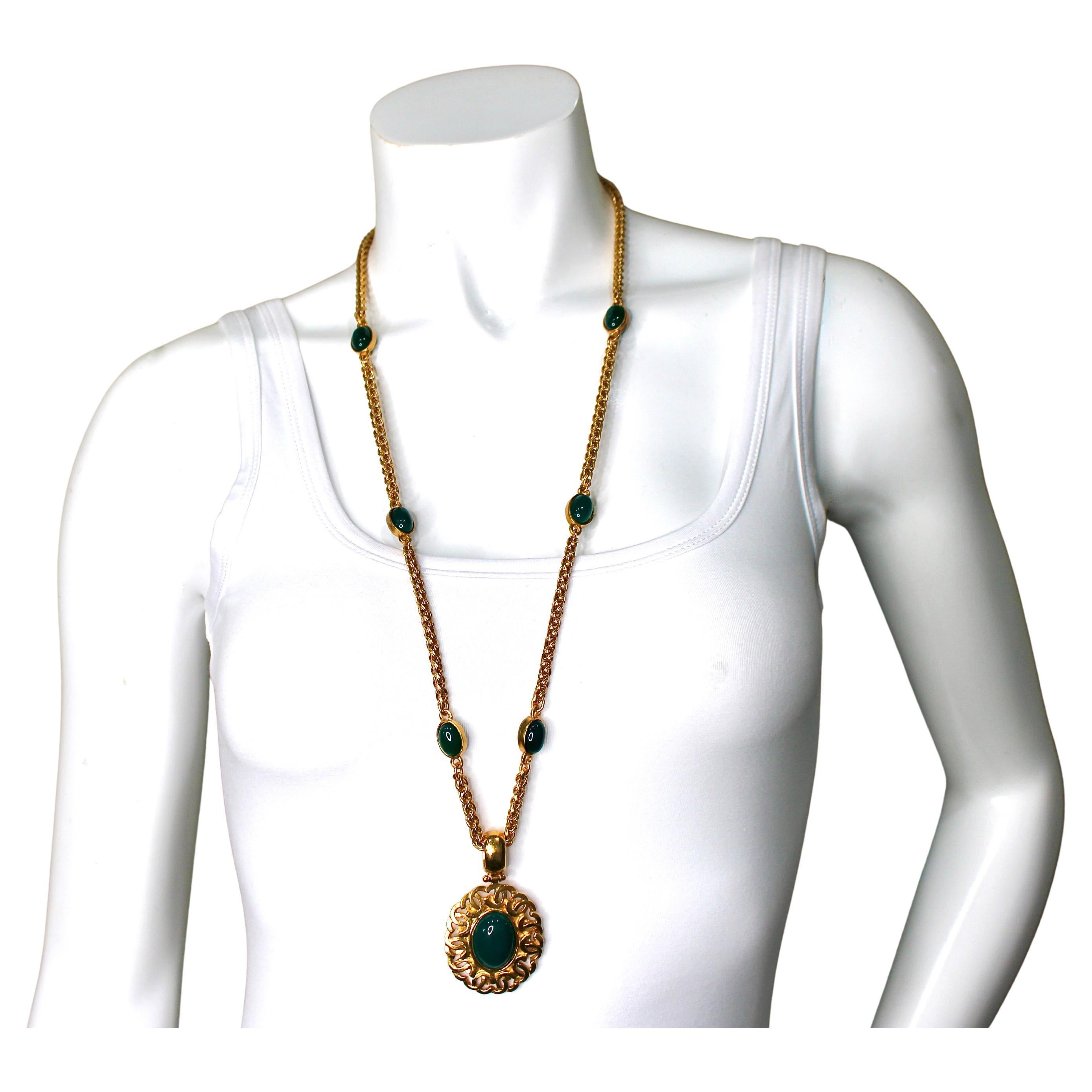 Le collier pendentif CC à cabochons verts, datant d'environ 1996, est un superbe exemple de bijou Chanel vintage, alliant l'élégance intemporelle à un design audacieux. Le collier est doté d'une luxueuse chaîne en corde dorée qui apporte une touche