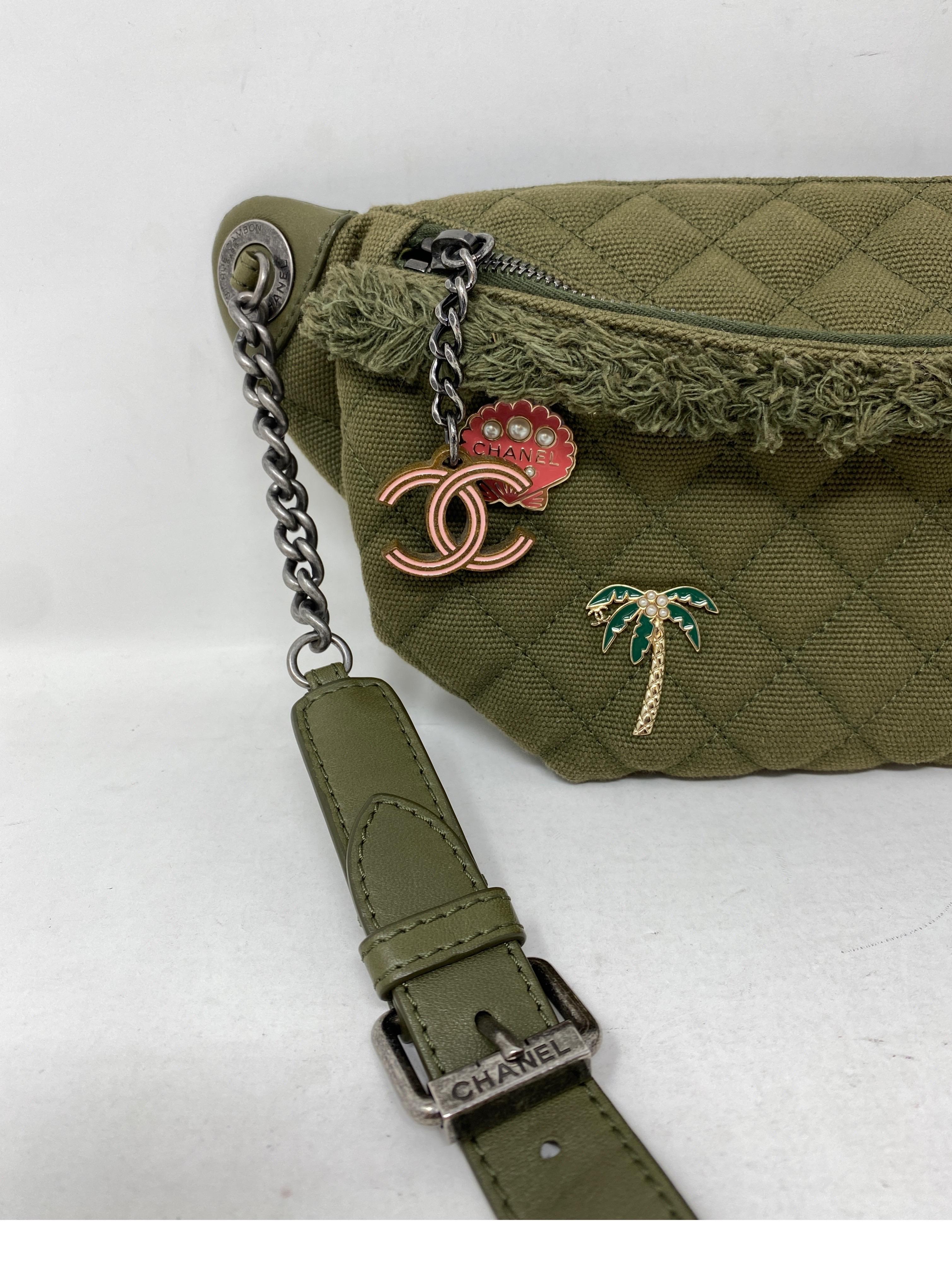 Chanel Fanny Pack. Green Canvas with Summer pins. Cuban collection. Tropical feel pins by Chanel. Khaki canvas with leather strap. Can be worn as a crossbody or a belt bag. Mint like new condition. Guaranteed authentic. 