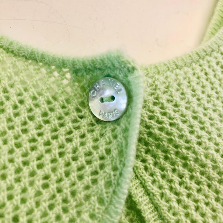 - Chanel green cashmere twin sets from 2000 Cruise collection. 

- Short Sleeves Cardigan and tank top. 

- One button closure. 

- Yellow sequined decorated on the cardigan. 

- Size 42. 

- 100% Cashmere. 