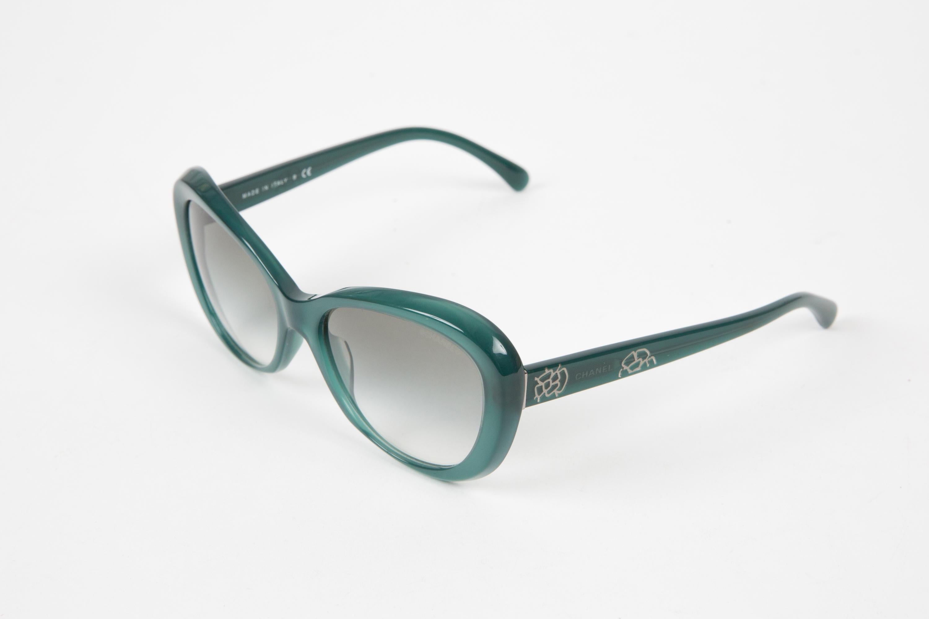 Chanel green cat-eye acetate sunglasses featuring Chanel signature detailing at the arm, cat-eye frame, straight arms with curved tips.
Circa 2000s.  100% acetate.
Arm Length 5.1in. (13cm)
Lens length:2in. (5.5cm)
Total width: 5.7in. (14.5cm)
In