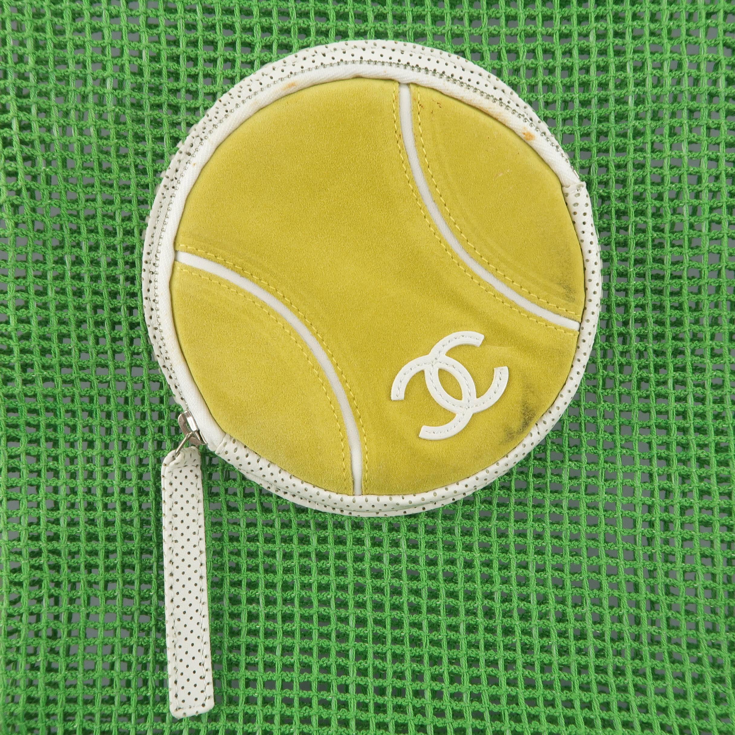 This rare vintage CHANEL tote bag comes in kelly green fishnet mesh with white perforated trim and features skinny double top handles, a snap top closure, and yellow suede CC tennis ball zip pocket front. Discolorations throughout from glue aging