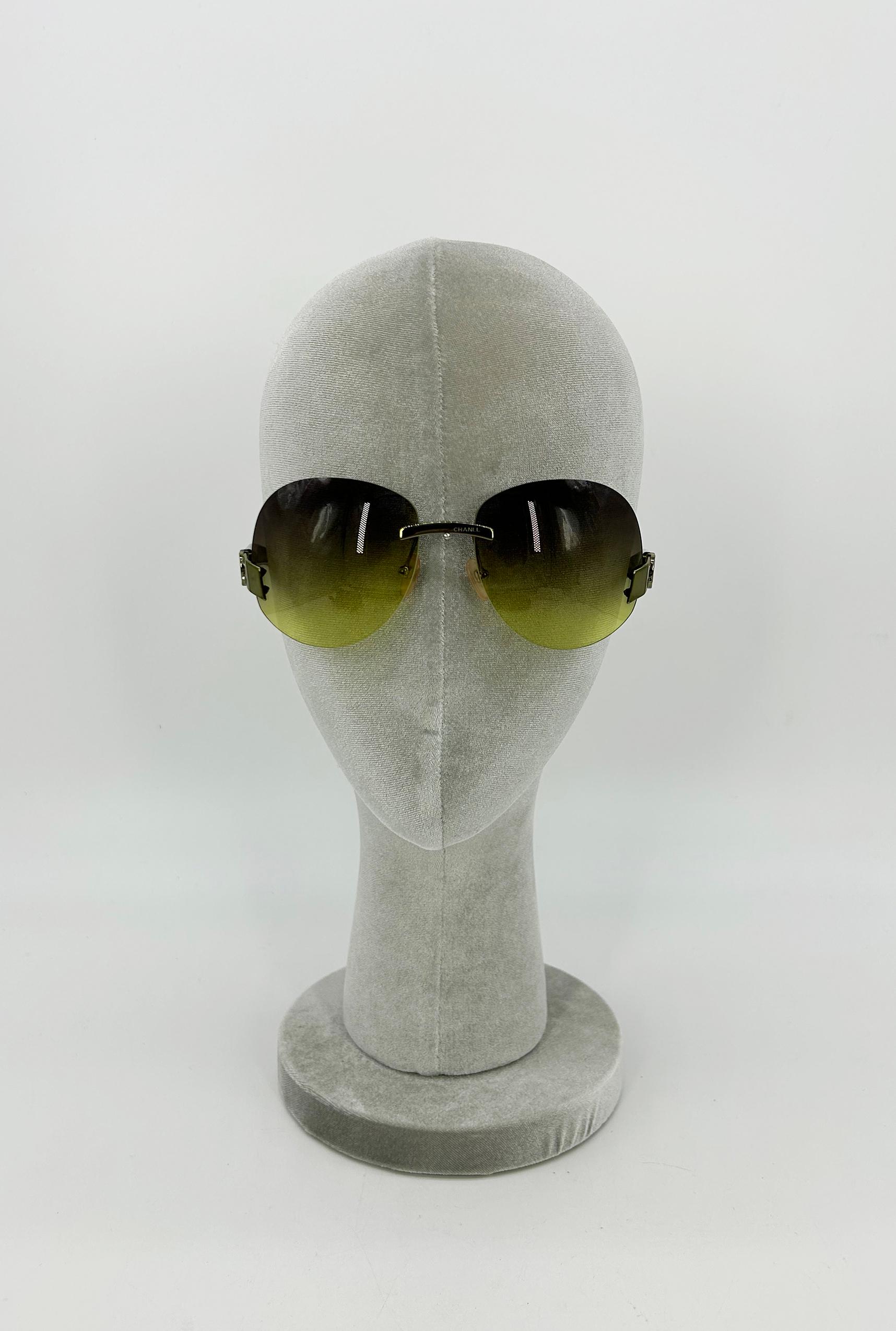 Chanel Green Lens CC Logo Arm Sunglasses c2000s in very good vintage condition. Green gradient square lenses trimmed with green hardware and acrylic arms. Signature interlocking CC logo upon both upper ends of arms at sides of lenses. Centered green