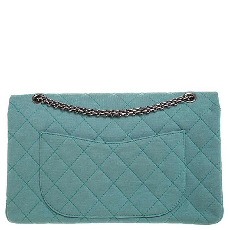 Chanel's Flap Bags are iconic and monumental in the history of fashion. This Reissue 2.55 Classic 227 is a buy that is worth every bit of your splurge. Exquisitely crafted from green jersey fabric, it bears their signature quilt pattern and the