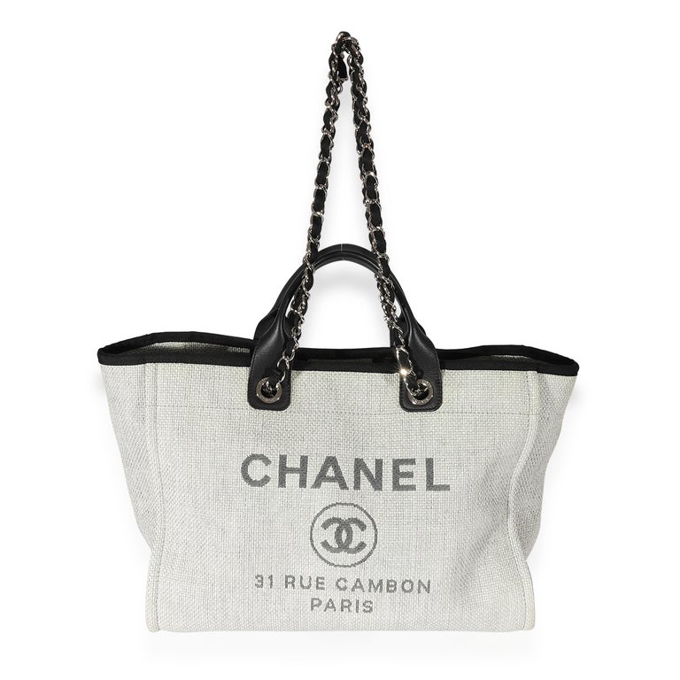 Listing Title: Chanel Grey & Black Canvas Large Deauville Tote
SKU: 127348
Condition: Pre-owned 
Handbag Condition: Very Good
Condition Comments: Very Good Condition. Plastic at some hardware. Exterior scuffing at corners. Interior light scuffing
