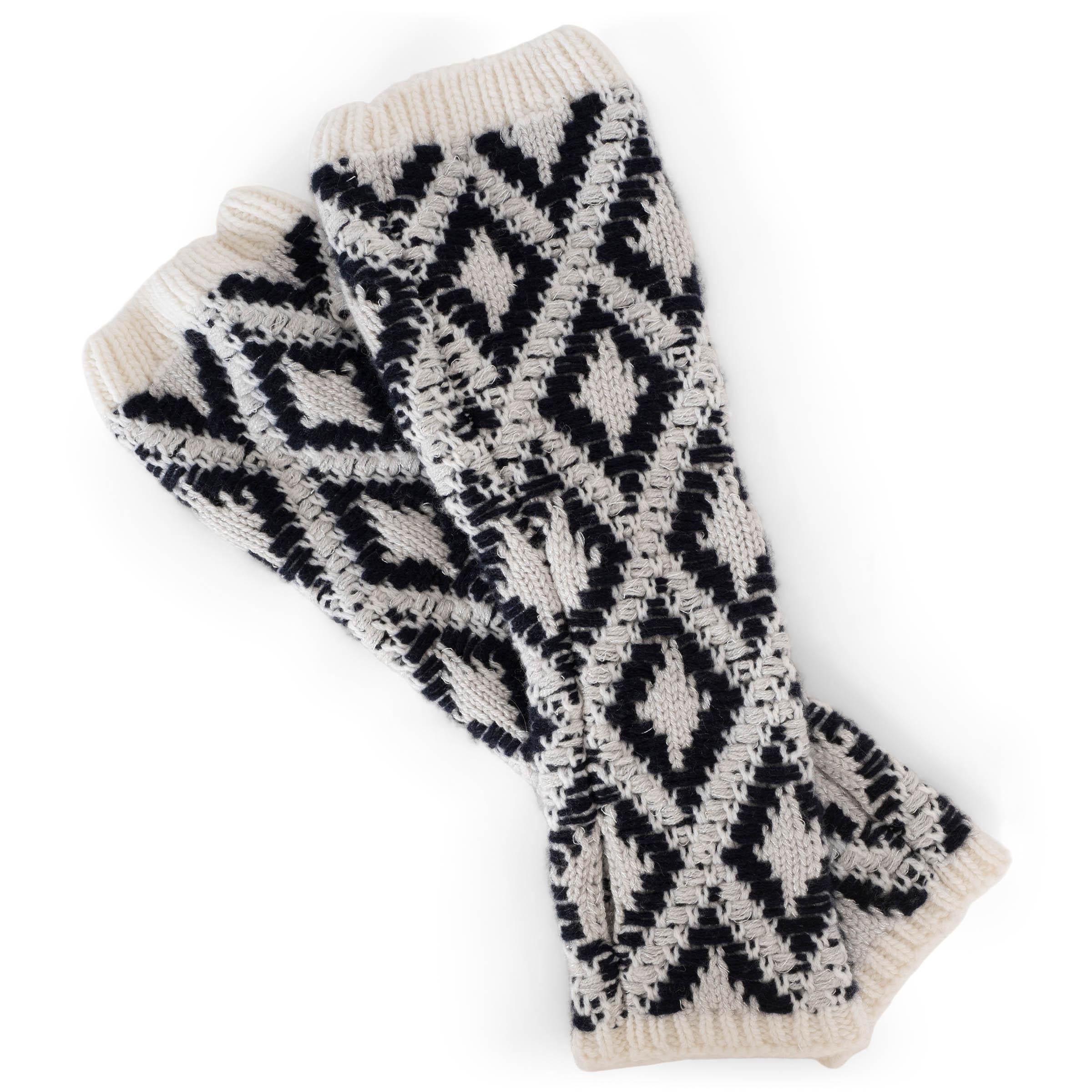These 100% authentic Chanel long fingerless knit gloves in light grey and black are crafted from a luxurious blend of cashmere (95%), viscose (3%), and metallized fiber (2%). They feature a thumb hole, rib-knit ends, and are adorned with the iconic