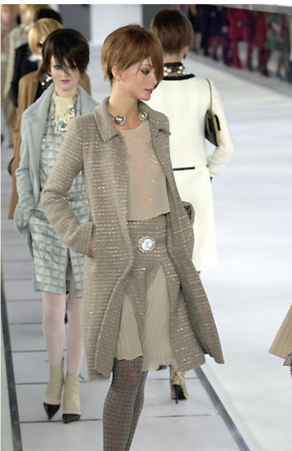 - Vintage Chanel grey/camel tweed coat and skirt ensemble with gold and silver sequins from Fall 2000 collection. The skirt has a pleated silk lace underneath. The whole outfit has a shiny effect.  

- Featuring a hook fastening at the collar with