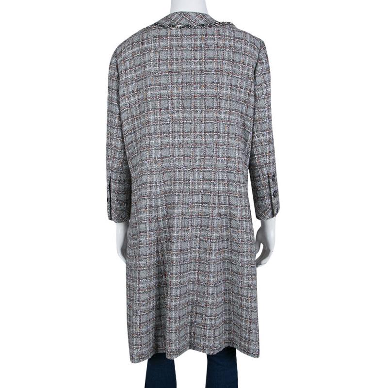 Keep yourself warm and cozy in Chanel's dress coat. A chic piece that will fabulously complement your evening separates and dresses; this coat flaunts the label's immaculate love for elegance and luxury. It is cut from a wool blend with silk lining
