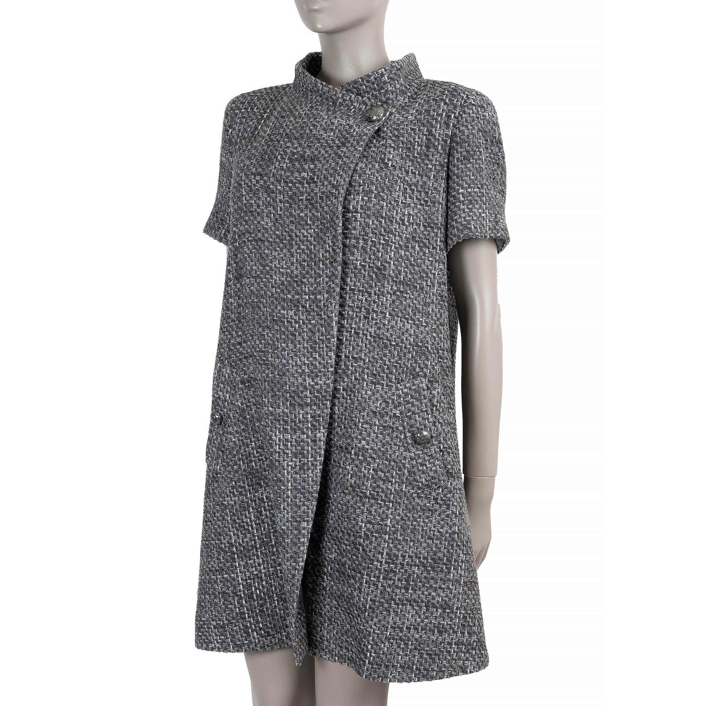 This 100% authentic Chanel jacket is crafted from grey and black chunky Lesage tweed in a blend of nylon (75%), cotton (21%), polyester (2%), and rayon (2%), subtly woven with silver lurex for a hint of shimmer. Designed with a fitted silhouette