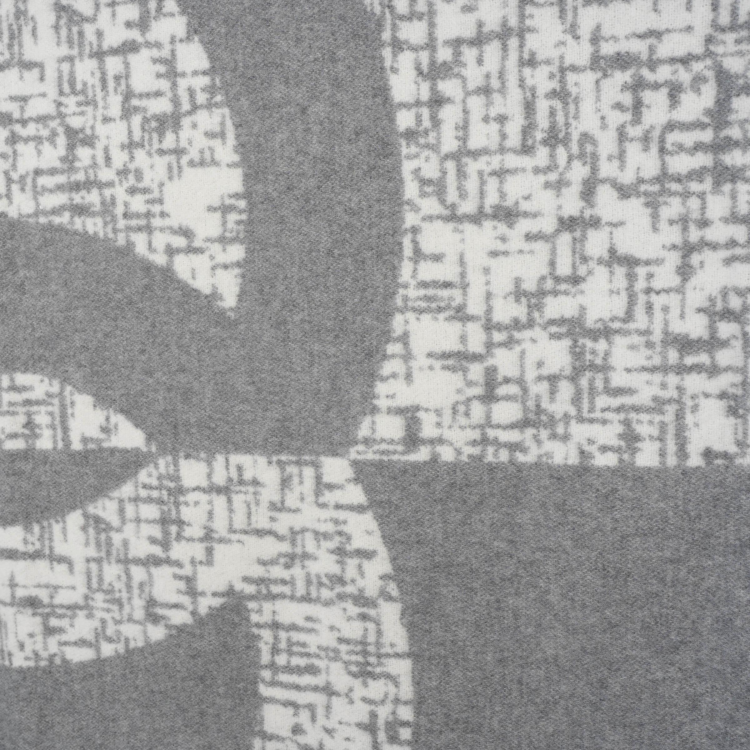 This 100% authentic Chanel blanket in grey and cream is crafted from a luxurious blend of cashmere (68%) and wool (32%). One half features a solid cream design, while the other showcases a grey and cream tweed-style jacquard weave, centered with an