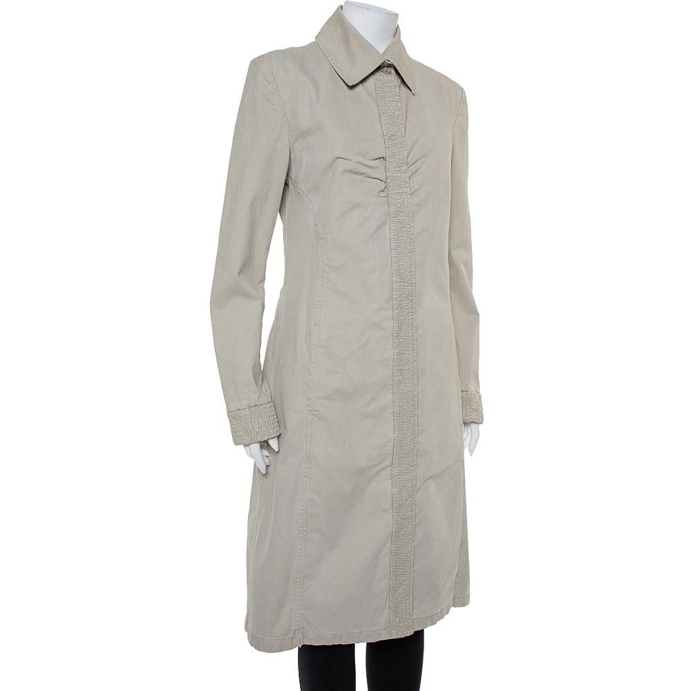 Always feel in sync with classic fashion by donning this Chanel coat. This piece will make a fashionable add-on to any outfit. It is tailored from denim fabric and designed in a long silhouette. The grey hue adds the perfect finishing element to