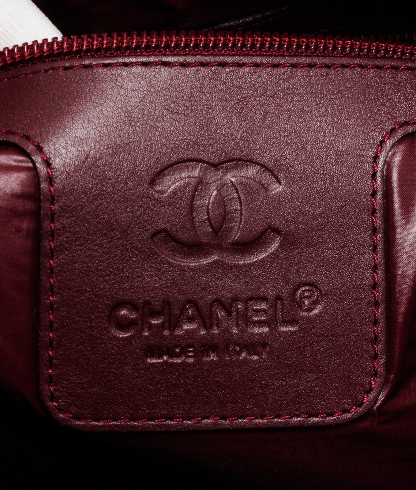 Grey denim quilted Chanel Coco Cocoon Messenger Bag with silver-tone hardware, tonal leather trim, single flat shoulder strap, single exterior zip pocket, embossed logo accent at front face, burgundy leather lining, single zip pocket at interior