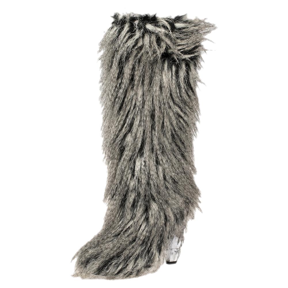 These Yeti boots from Chanel are anything but ordinary! Covered in grey faux fur, they exhibit an eye-catching exterior. They are endowed with comfortable leather-lined insoles and are elevated on 12 cm heels. A statement pair like this definitely