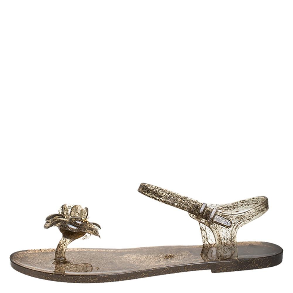 The house of Chanel brings you these impressive sandals that will complement any outfit. These gorgeous sandals made of jelly add a classic touch to your look. These grey glitter sandals add glamour. They come with buckled ankle straps and gold-tone